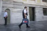 G4S employee walking with suitcase