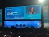 Large conference room with young woman presenting